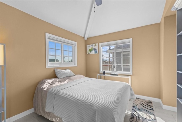 bedroom with vaulted ceiling, light tile patterned floors, and ceiling fan