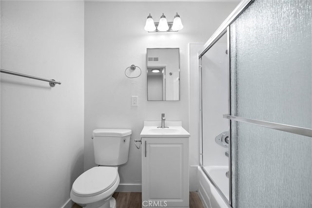 full bathroom featuring enclosed tub / shower combo, vanity, toilet, and wood-type flooring