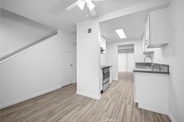 kitchen featuring white cabinetry, sink, electric range, ceiling fan, and light wood-type flooring