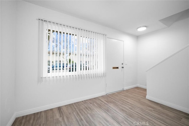 unfurnished room featuring hardwood / wood-style flooring