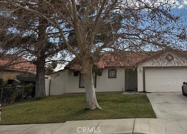 view of front of property with a garage and a front lawn