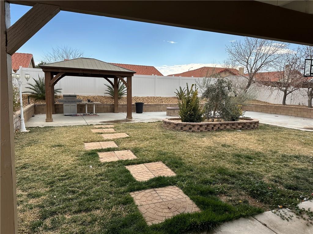 view of yard featuring a gazebo, area for grilling, and a patio area