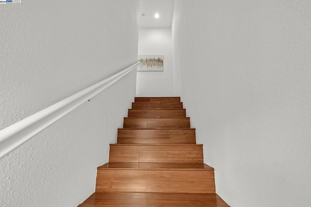 stairs featuring hardwood / wood-style flooring