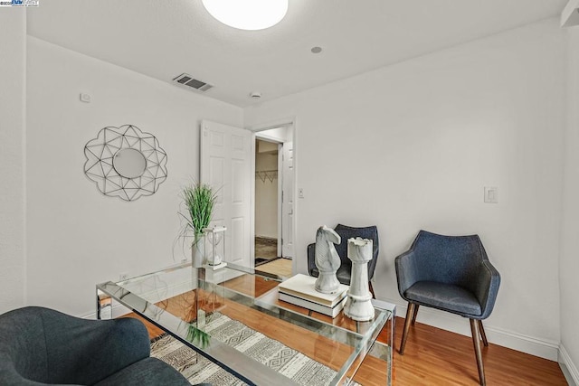 sitting room with wood-type flooring