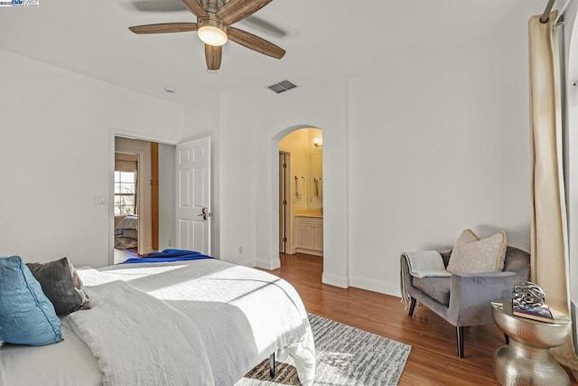 bedroom featuring ceiling fan, connected bathroom, and light hardwood / wood-style flooring