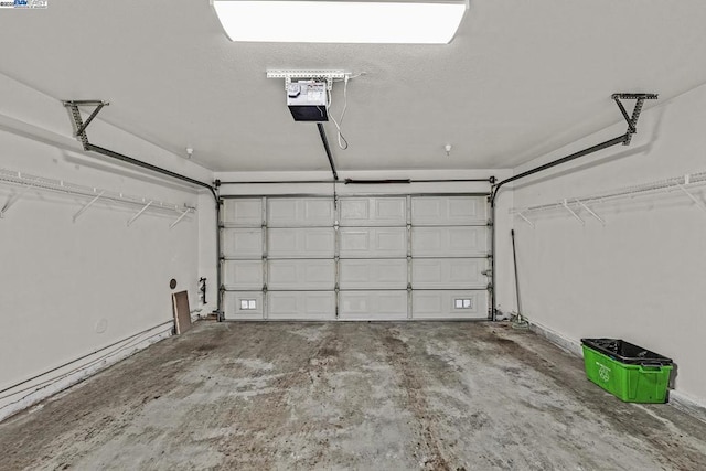 garage featuring baseboard heating and a garage door opener