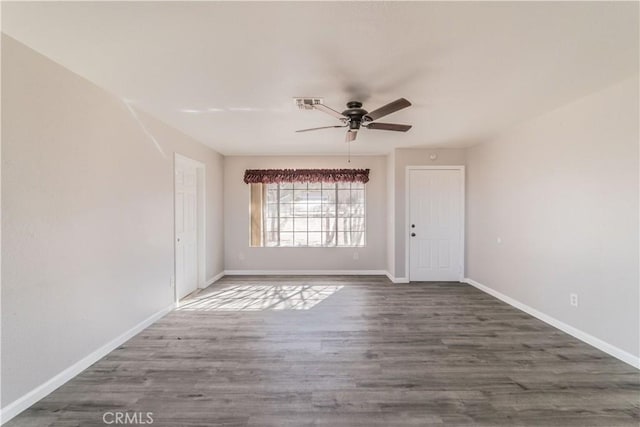 unfurnished room with dark hardwood / wood-style floors and ceiling fan