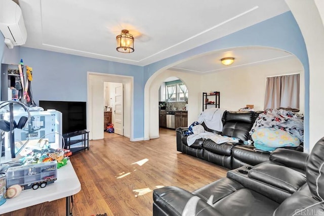 living room with wood-type flooring and an AC wall unit