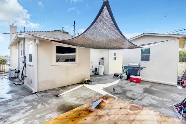 back of property with a patio