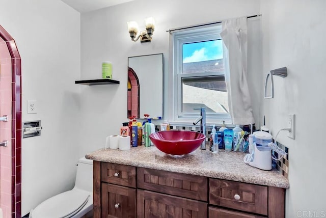 bathroom featuring vanity and toilet