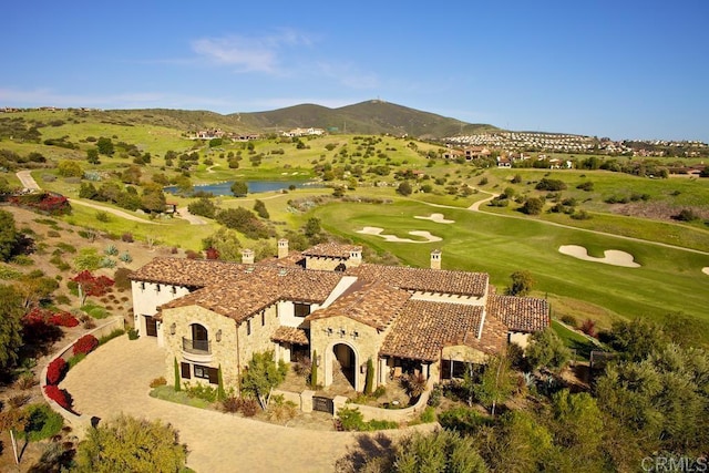 birds eye view of property with a water and mountain view