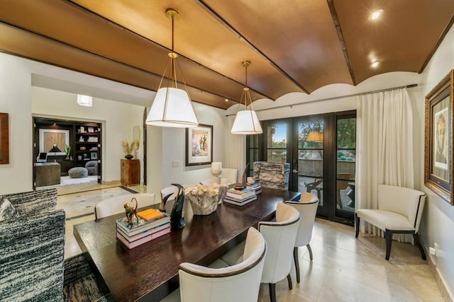 dining area featuring vaulted ceiling and french doors