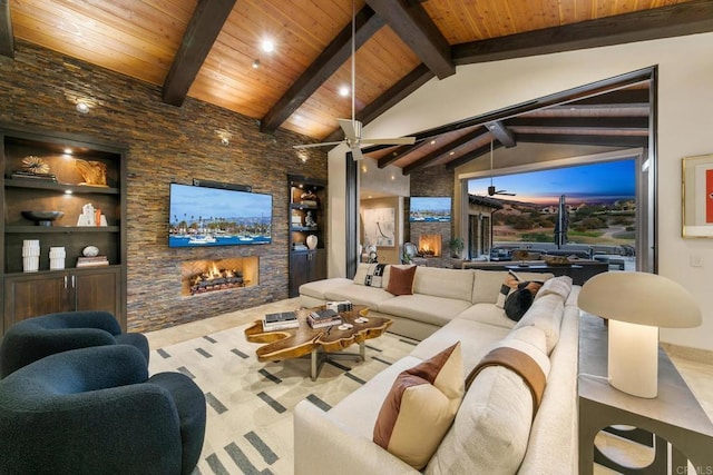 living room with vaulted ceiling with beams, a stone fireplace, and wooden ceiling