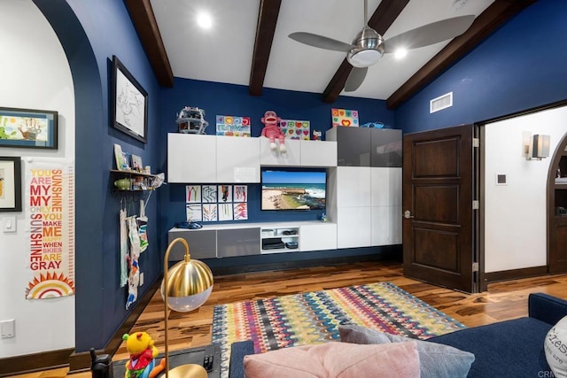 game room with wood-type flooring, lofted ceiling with beams, and ceiling fan