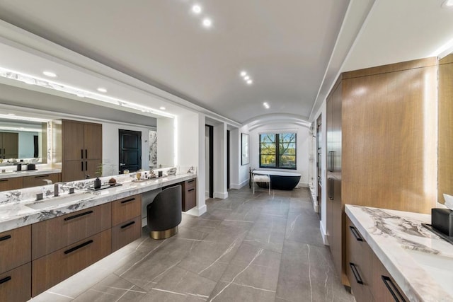 bathroom with vanity and a bath