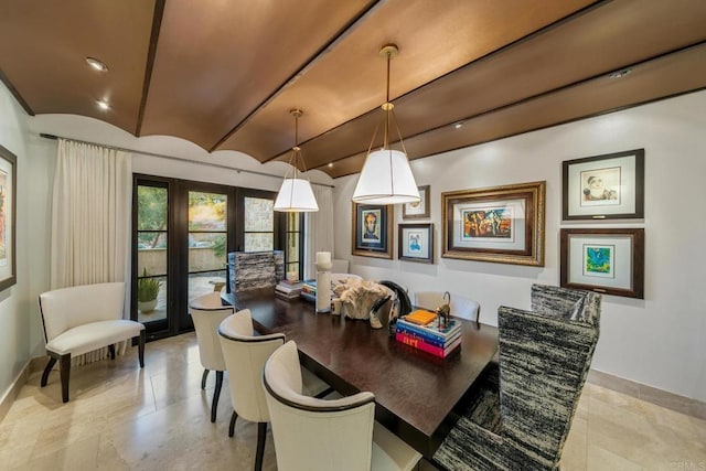 dining room featuring vaulted ceiling and french doors