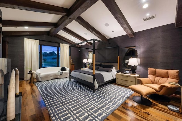 bedroom featuring vaulted ceiling with beams and hardwood / wood-style flooring