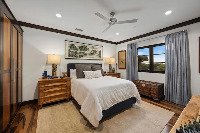 bedroom featuring crown molding, ceiling fan, and light wood-type flooring