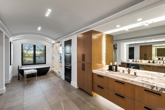 bathroom featuring vanity, lofted ceiling, and plus walk in shower