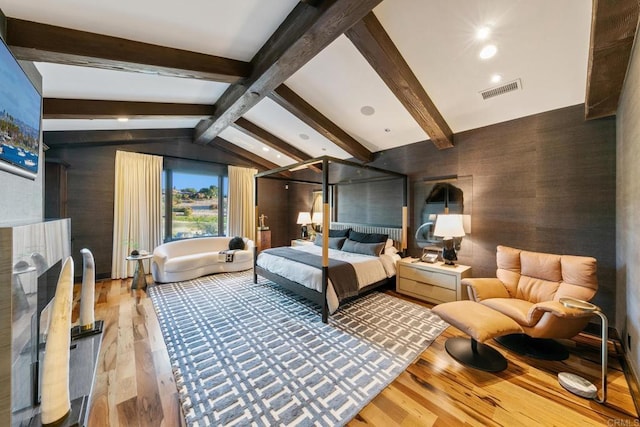 bedroom featuring lofted ceiling with beams and wood-type flooring