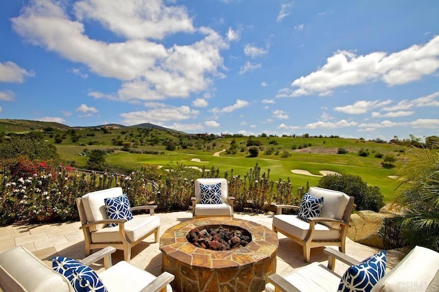 view of patio / terrace with an outdoor living space with a fire pit