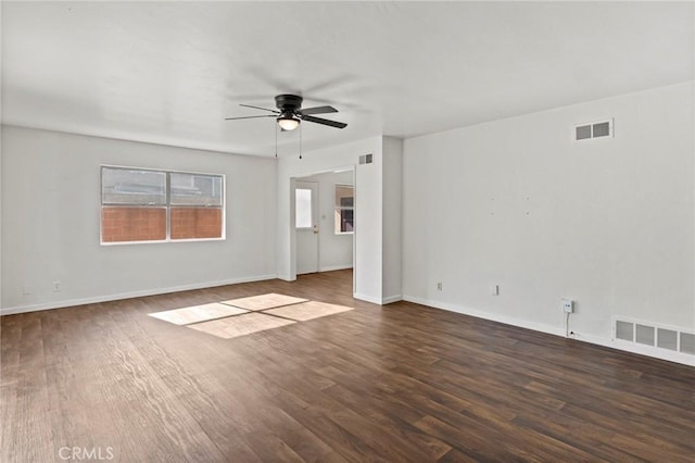 spare room with dark wood-type flooring and ceiling fan