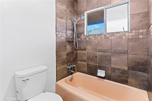 bathroom featuring tiled shower / bath and toilet