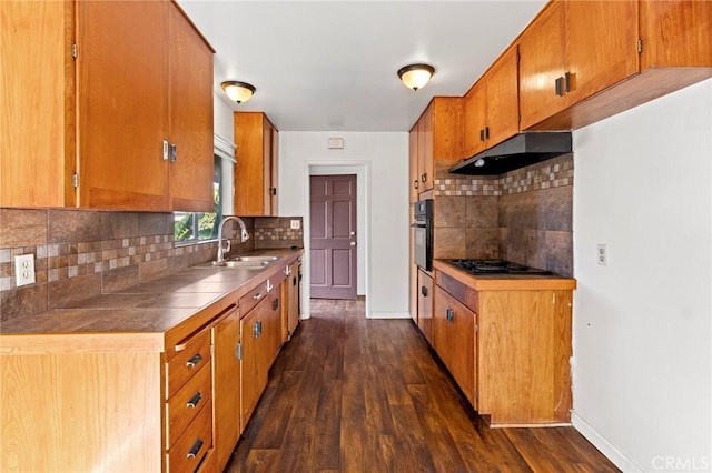 kitchen featuring dark hardwood / wood-style floors, black gas stovetop, sink, and wall oven