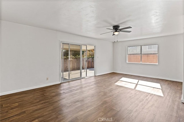 empty room with ceiling fan and dark hardwood / wood-style flooring