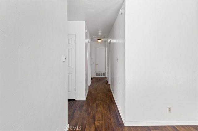 corridor featuring dark hardwood / wood-style flooring