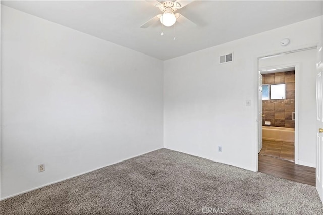 spare room with ceiling fan and carpet flooring