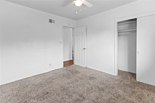 unfurnished bedroom featuring ceiling fan, carpet floors, and a closet