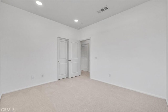 spare room with light colored carpet