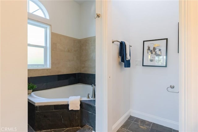 bathroom featuring tiled tub