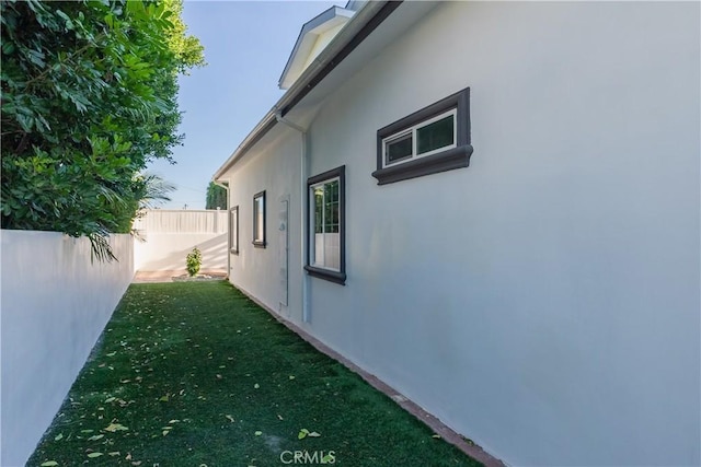 view of side of home featuring a lawn