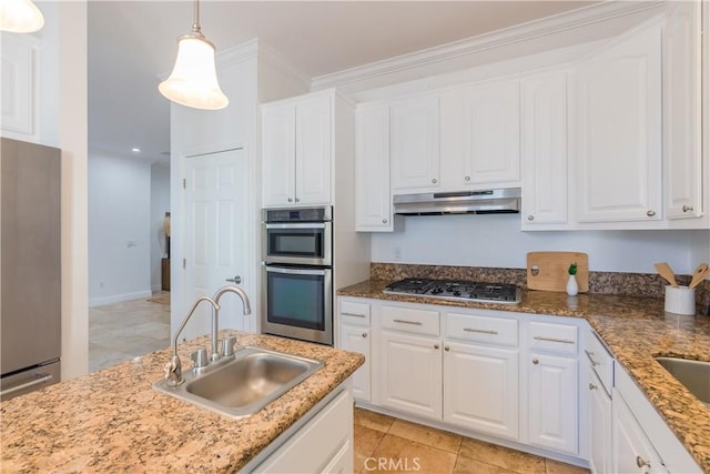 kitchen with white cabinetry, stainless steel appliances, sink, and hanging light fixtures