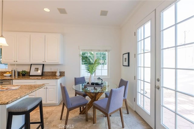 tiled dining area featuring french doors and ornamental molding