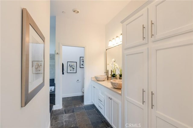 bathroom featuring vanity and toilet