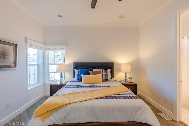 bedroom with crown molding and hardwood / wood-style flooring