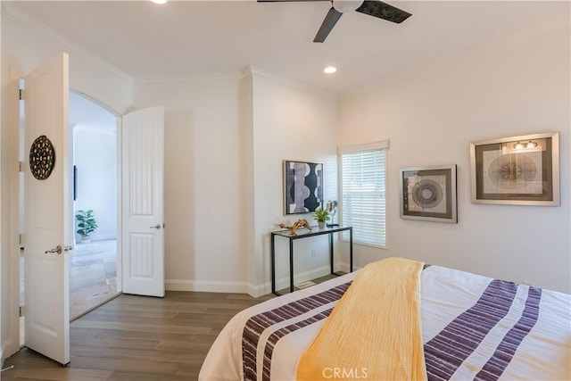 bedroom featuring hardwood / wood-style flooring, ornamental molding, and ceiling fan