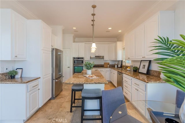 kitchen with pendant lighting, white cabinetry, stainless steel appliances, and dark stone counters