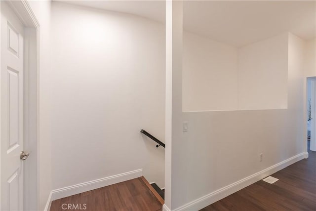 stairway with hardwood / wood-style floors