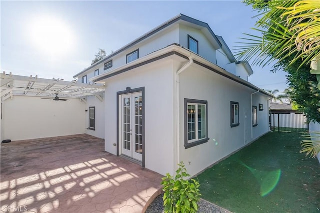 view of side of property featuring a patio area and a pergola