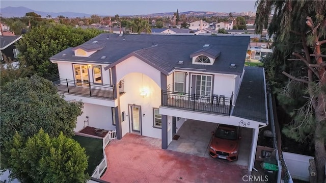 back of property with a balcony and a mountain view