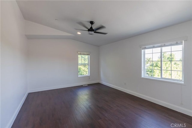 empty room featuring lofted ceiling, dark wood-type flooring, and ceiling fan