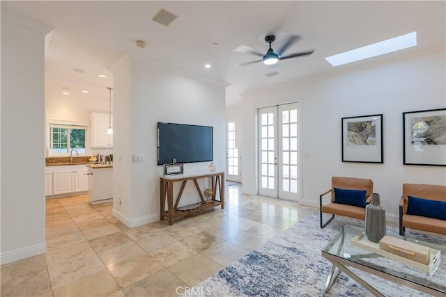 living room featuring french doors, ceiling fan, plenty of natural light, and light tile patterned flooring