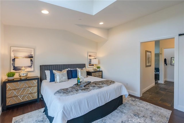 bedroom with lofted ceiling and dark hardwood / wood-style flooring