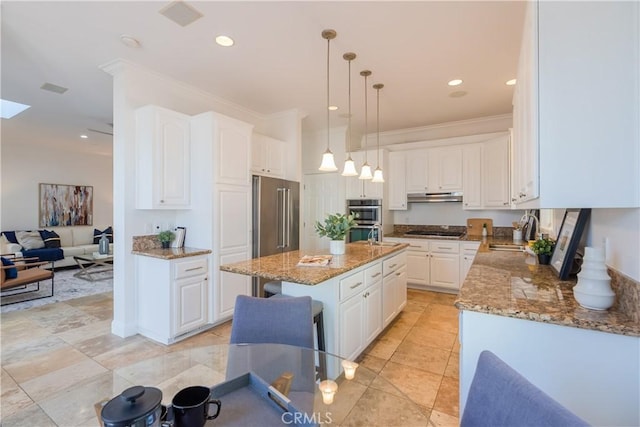 kitchen featuring white cabinetry, appliances with stainless steel finishes, a center island, and sink