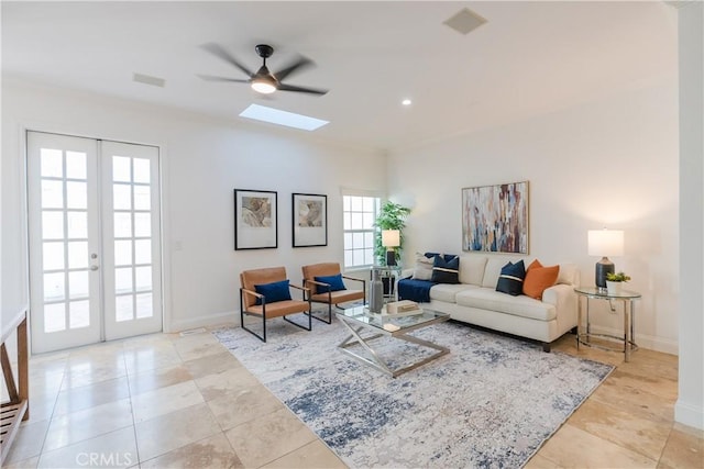 living room with french doors, ceiling fan, a skylight, and light tile patterned floors