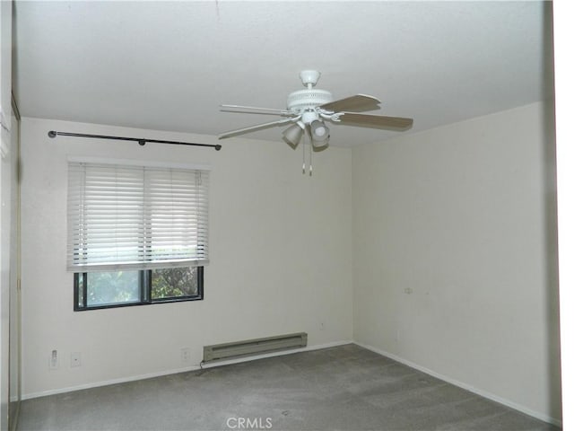 empty room featuring ceiling fan, light colored carpet, and a baseboard heating unit